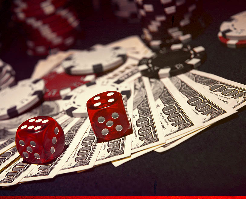 money on casino table with chips and dice